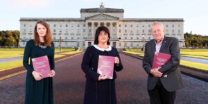 Truth Recovery Panel standing in front of Stormont holding reports.